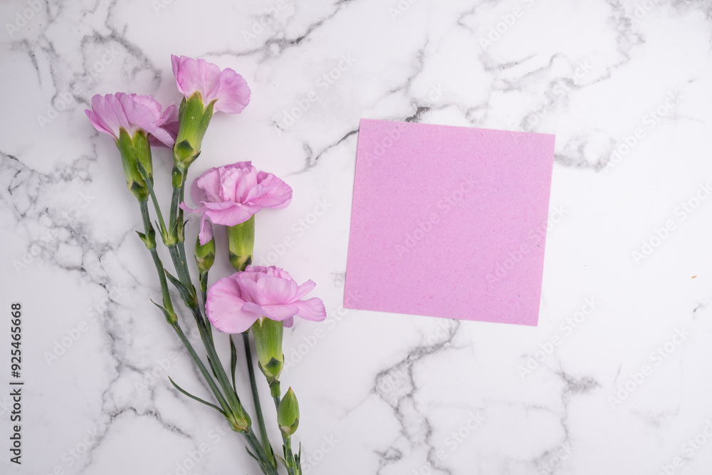 Obraz premium Invitation mockup with pink carnation flowers on light background, copy space for card design. Wedding invitation. International Women's Day, Mother's Day concept