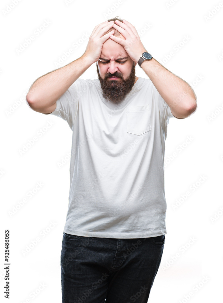 Young caucasian hipster man wearing casual t-shirt over isolated background suffering from headache desperate and stressed because pain and migraine. Hands on head. Young caucasian hipster man wearing casual t-shirt over isolated background suffering from headache desperate and stressed because pain and migraine. Hands on head.