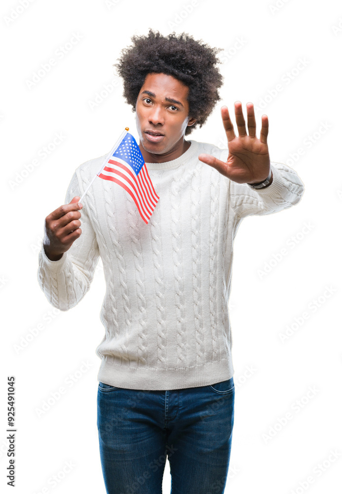 Afro american man flag of United States of America over isolated background with open hand doing stop sign with serious and confident expression, defense gesture Afro american man flag of United States of America over isolated background with open hand doing stop sign with serious and confident expression, defense gesture