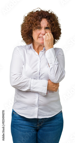 Beautiful middle ager senior businees woman over isolated background looking stressed and nervous with hands on mouth biting nails. Anxiety problem. photo