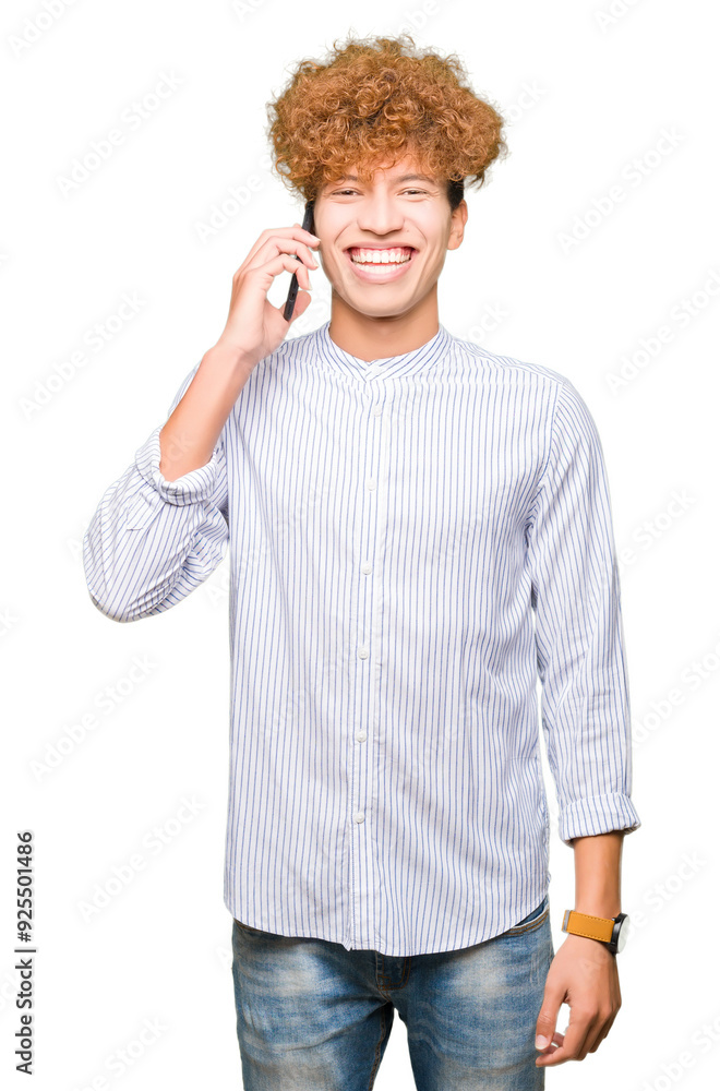 Young handsome man talking on the phone with a happy face standing and smiling with a confident smile showing teeth Young handsome man talking on the phone with a happy face standing and smiling with a confident smile showing teeth