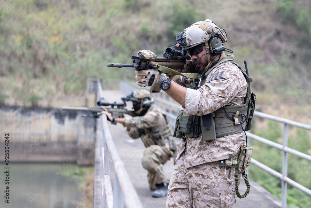 Soldiers in camouflage military uniforms on a mission Soldiers in camouflage military uniforms on a mission