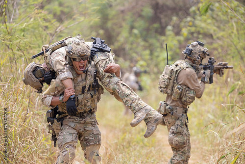 Photos oldier carried the injured fellow  from the mission in the forest