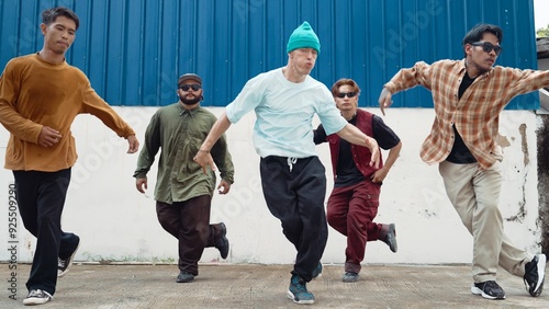 Group of hip hop choreographer dancing street dance together at wall. Young break dancer practicing break dance, moving to modern rhythm, express feeling of lively. Outdoor 2024. Hiphop.