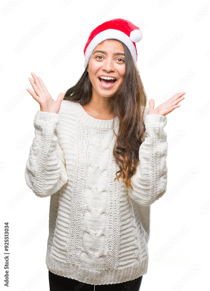 Young arab woman wearing christmas hat over isolated background celebrating crazy and amazed for success with arms raised and open eyes screaming excited. Winner concept Young arab woman wearing christmas hat over isolated background celebrating crazy and amazed for success with arms raised and open eyes screaming excited. Winner concept