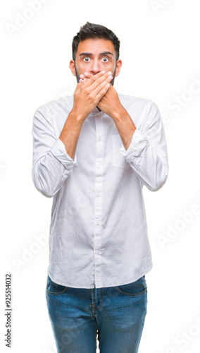 Adult hispanic man over isolated background shocked covering mouth with hands for mistake. Secret concept.