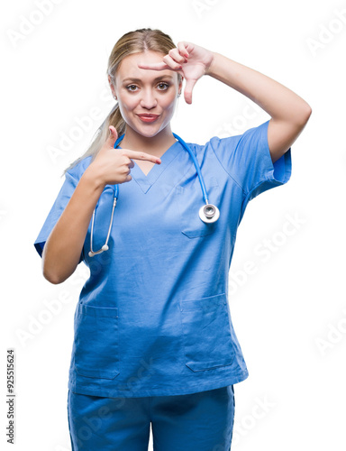 Young blonde surgeon doctor woman over isolated background smiling making frame with hands and fingers with happy face. Creativity and photography concept.