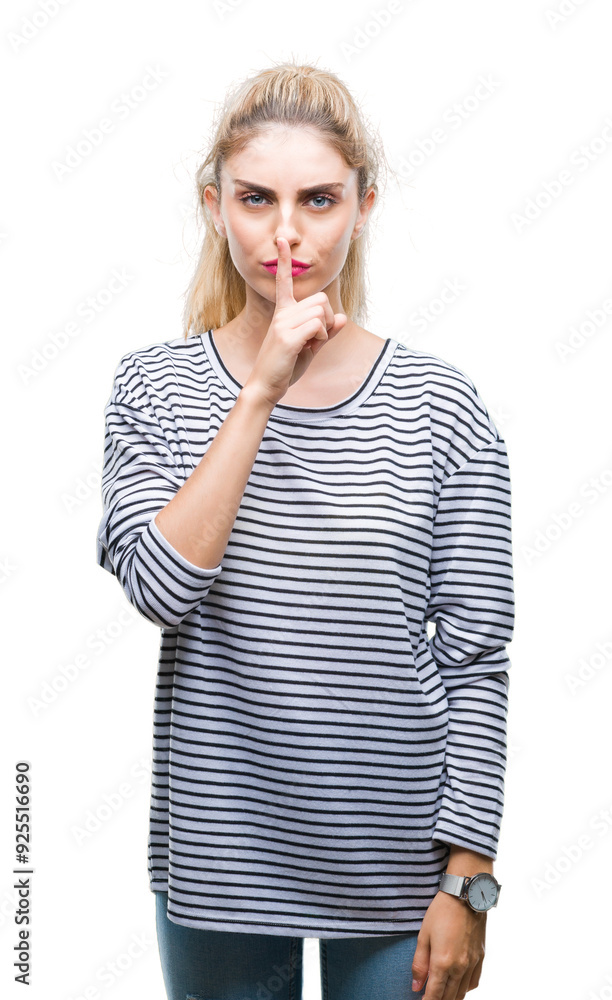 Young beautiful blonde woman wearing stripes sweater over isolated background asking to be quiet with finger on lips. Silence and secret concept. Young beautiful blonde woman wearing stripes sweater over isolated background asking to be quiet with finger on lips. Silence and secret concept.