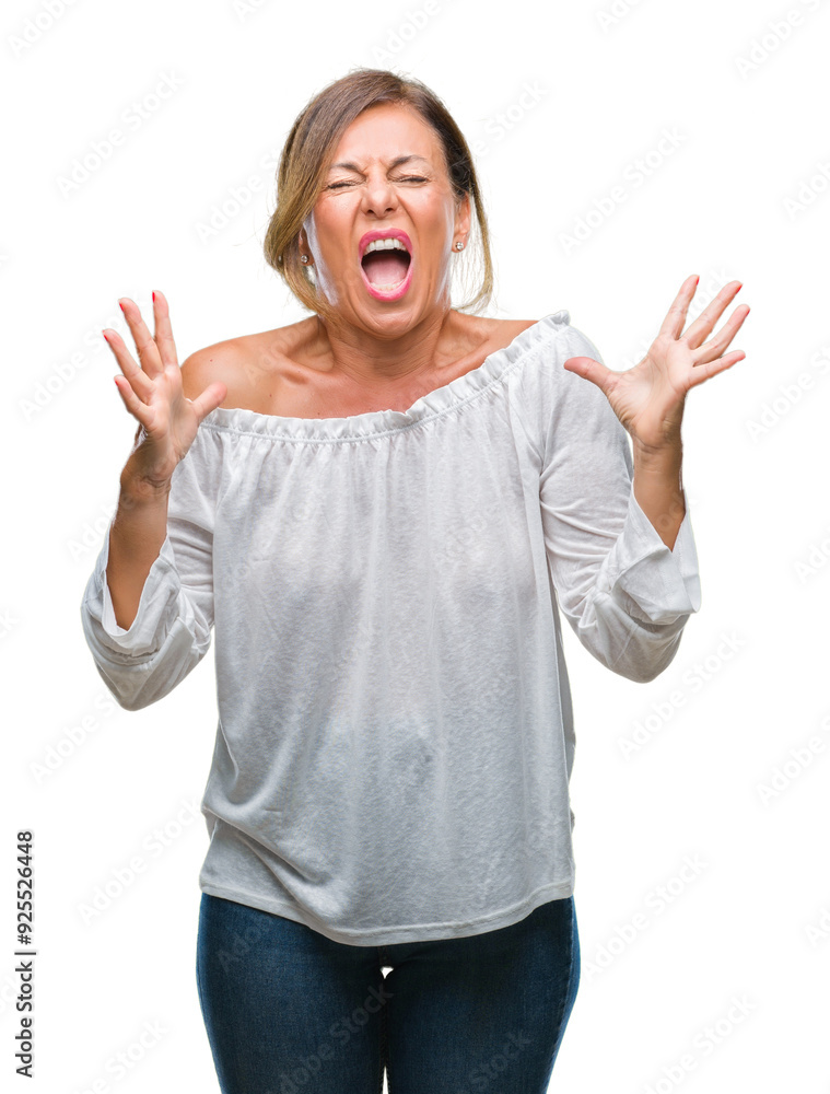 Middle age senior hispanic woman over isolated background crazy and mad shouting and yelling with aggressive expression and arms raised. Frustration concept. Middle age senior hispanic woman over isolated background crazy and mad shouting and yelling with aggressive expression and arms raised. Frustration concept.
