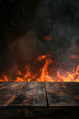 Empty wooden tabletop burning with hot flames and sparks on black background