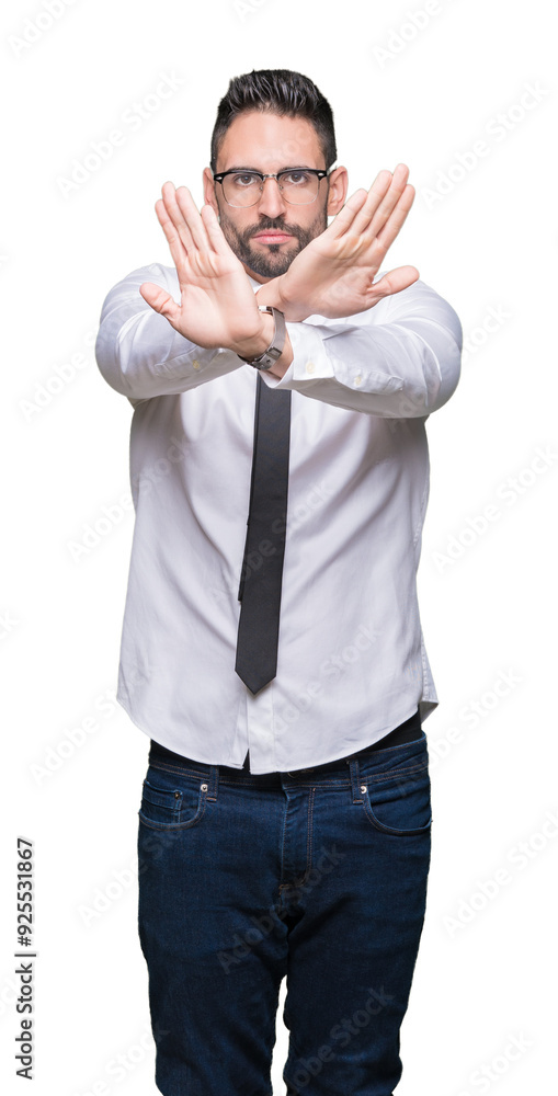 Fototapeta premium Young handsome business man wearing glasses over isolated background Rejection expression crossing arms and palms doing negative sign, angry face