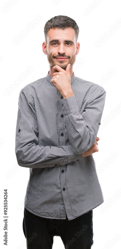Young hipster man looking confident at the camera with smile with crossed arms and hand raised on chin. Thinking positive. Young hipster man looking confident at the camera with smile with crossed arms and hand raised on chin. Thinking positive.