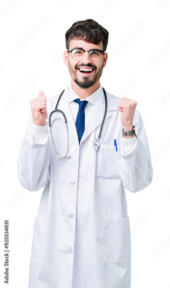 Young doctor man wearing hospital coat over isolated background celebrating surprised and amazed for success with arms raised and open eyes. Winner concept. Young doctor man wearing hospital coat over isolated background celebrating surprised and amazed for success with arms raised and open eyes. Winner concept.
