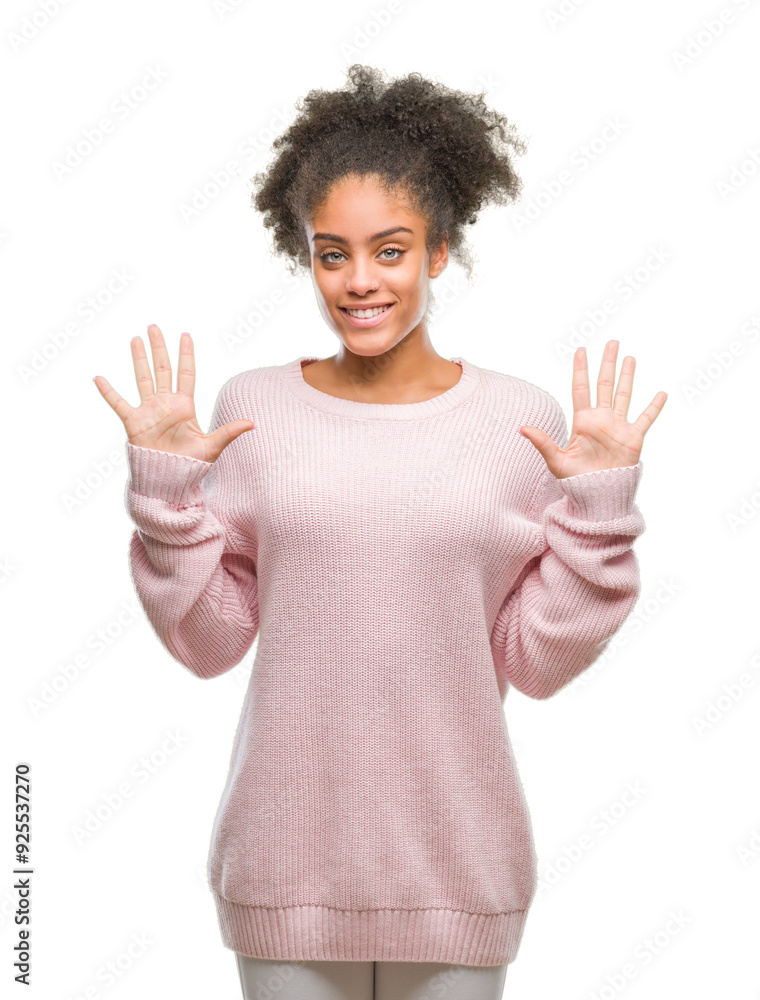 Young afro american woman wearing winter sweater over isolated background showing and pointing up with fingers number ten while smiling confident and happy. Young afro american woman wearing winter sweater over isolated background showing and pointing up with fingers number ten while smiling confident and happy.