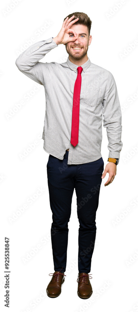 Young handsome business man doing ok gesture with hand smiling, eye looking through fingers with happy face. Young handsome business man doing ok gesture with hand smiling, eye looking through fingers with happy face.