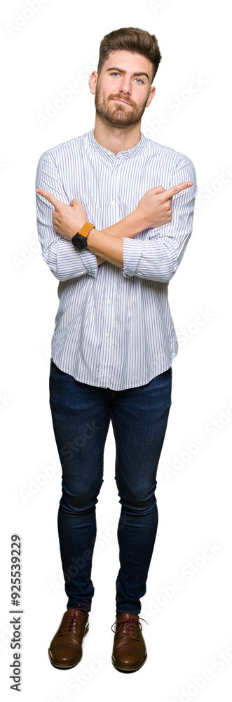 Young handsome man Pointing to both sides with fingers, different direction disagree Young handsome man Pointing to both sides with fingers, different direction disagree