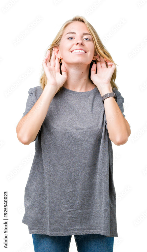 Beautiful young woman wearing oversize casual t-shirt over isolated background Trying to hear both hands on ear gesture, curious for gossip. Hearing problem, deaf Beautiful young woman wearing oversize casual t-shirt over isolated background Trying to hear both hands on ear gesture, curious for gossip. Hearing problem, deaf