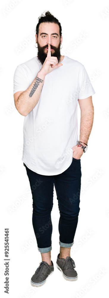 Young hipster man with long hair and beard wearing casual white t-shirt asking to be quiet with finger on lips. Silence and secret concept. Young hipster man with long hair and beard wearing casual white t-shirt asking to be quiet with finger on lips. Silence and secret concept.