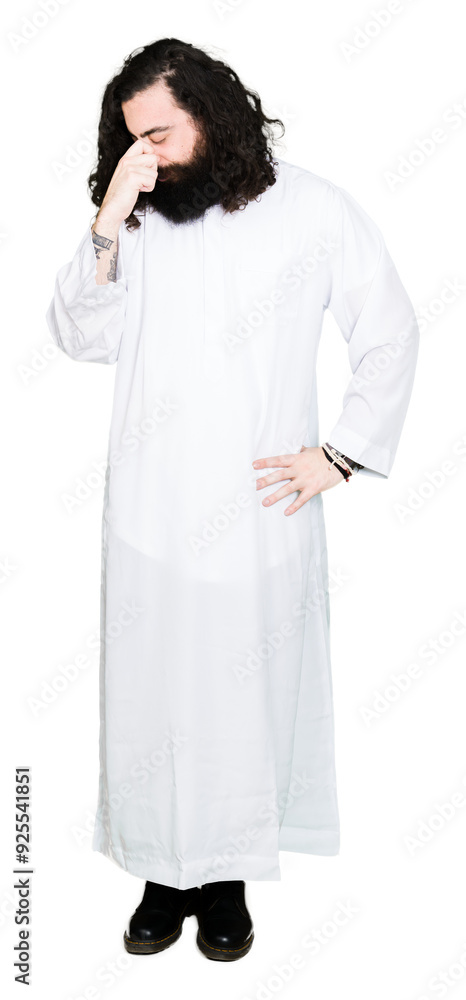 Man wearing Jesus Christ costume tired rubbing nose and eyes feeling fatigue and headache. Stress and frustration concept. Man wearing Jesus Christ costume tired rubbing nose and eyes feeling fatigue and headache. Stress and frustration concept.