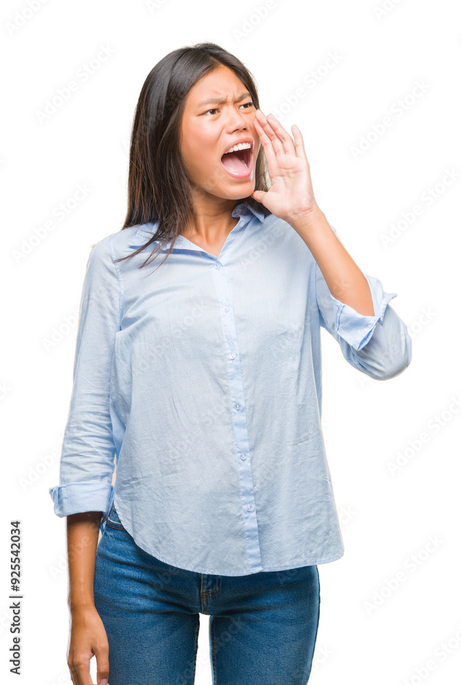 Young asian business woman over isolated background shouting and screaming loud to side with hand on mouth. Communication concept. Young asian business woman over isolated background shouting and screaming loud to side with hand on mouth. Communication concept.