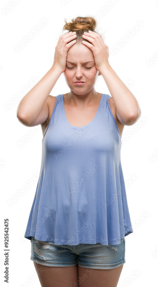 Young blonde woman suffering from headache desperate and stressed because pain and migraine. Hands on head. Young blonde woman suffering from headache desperate and stressed because pain and migraine. Hands on head.