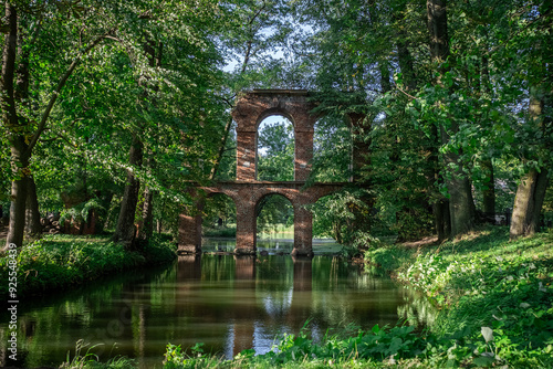old ancient aqueduct in romantic Arcadia park, antique Roman architecture made of brick wall, historical building, Poland
