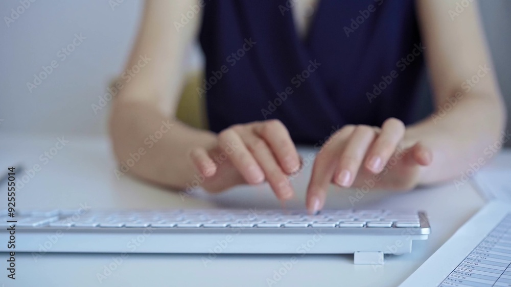 Businesswoman with dark blue blues blues is working on a computer keyboard in the office. Business concept Businesswoman with dark blue blues blues is working on a computer keyboard in the office. Business concept