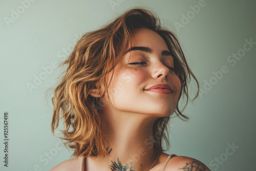 A close up of a woman's face with tattoos and her eyes closed