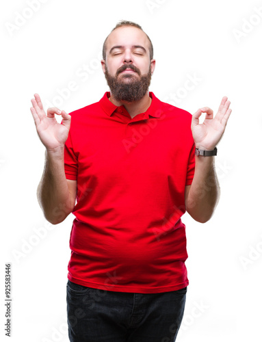 Young caucasian hipster man wearing red shirt over isolated background relax and smiling with eyes closed doing meditation gesture with fingers. Yoga concept.