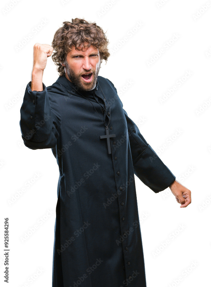 Handsome hispanic catholic priest man over isolated background angry and mad raising fist frustrated and furious while shouting with anger. Rage and aggressive concept. Handsome hispanic catholic priest man over isolated background angry and mad raising fist frustrated and furious while shouting with anger. Rage and aggressive concept.