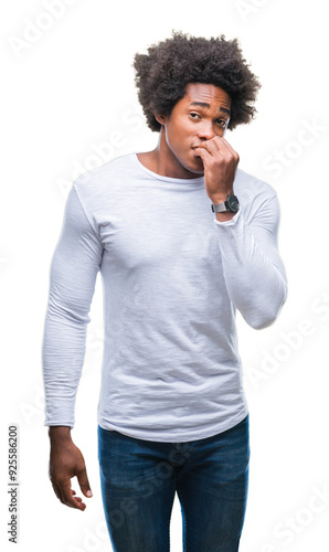 Afro american man over isolated background looking stressed and nervous with hands on mouth biting nails. Anxiety problem.