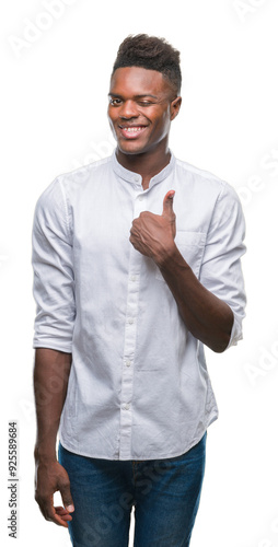 Young african american man over isolated background doing happy thumbs up gesture with hand. Approving expression looking at the camera with showing success.