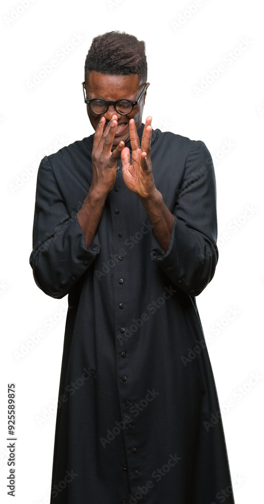 Young african american priest man over isolated background smelling something stinky and disgusting, intolerable smell, holding breath with fingers on nose. Bad smells concept. Young african american priest man over isolated background smelling something stinky and disgusting, intolerable smell, holding breath with fingers on nose. Bad smells concept.