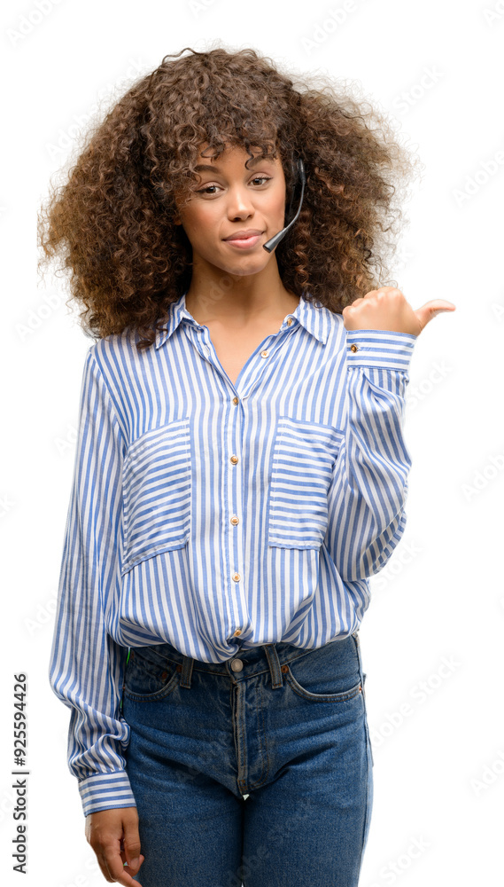 African american call center operator woman pointing with hand and finger up with happy face smiling African american call center operator woman pointing with hand and finger up with happy face smiling