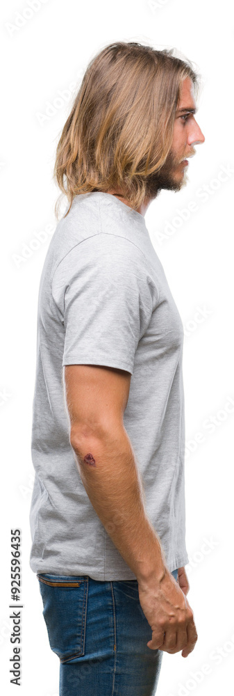 Young handsome man with long hair over isolated background looking to side, relax profile pose with natural face with confident smile. Young handsome man with long hair over isolated background looking to side, relax profile pose with natural face with confident smile.