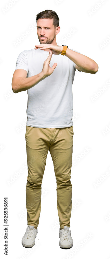 Handsome man wearing casual white t-shirt Doing time out gesture with hands, frustrated and serious face Handsome man wearing casual white t-shirt Doing time out gesture with hands, frustrated and serious face