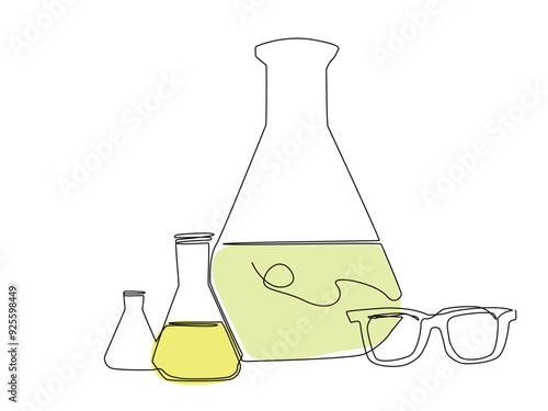 A collection of laboratory glassware filled with yellow liquid accompanied by protective eyewear, emphasizing a scientific environment.