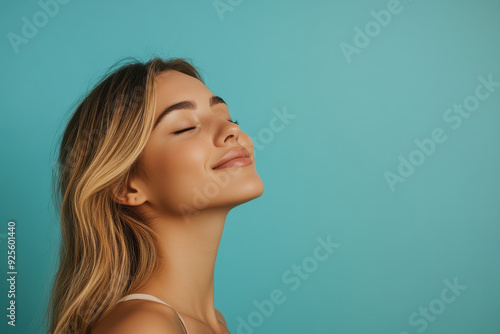 A close up of a woman's face with her eyes closed and long blond hair