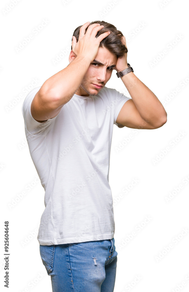 Young handsome man wearing white t-shirt over isolated background suffering from headache desperate and stressed because pain and migraine. Hands on head.