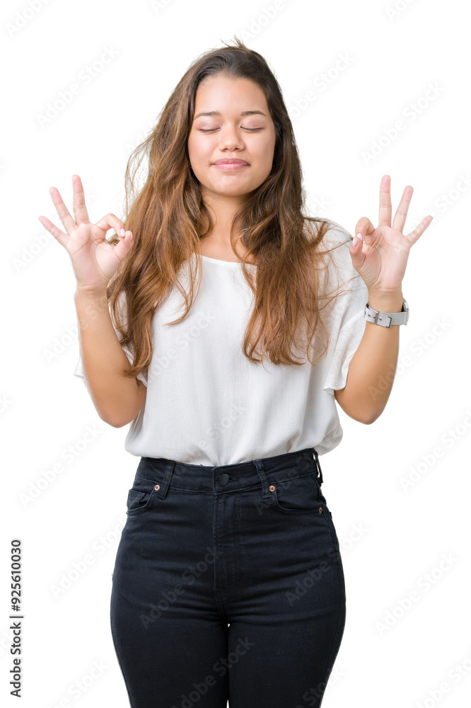 Young beautiful brunette business woman over isolated background relax and smiling with eyes closed doing meditation gesture with fingers. Yoga concept. Young beautiful brunette business woman over isolated background relax and smiling with eyes closed doing meditation gesture with fingers. Yoga concept.