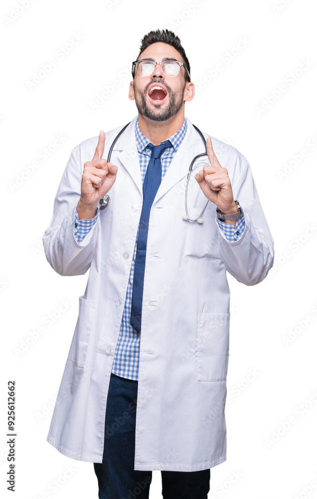 Handsome young doctor man over isolated background amazed and surprised looking up and pointing with fingers and raised arms. Handsome young doctor man over isolated background amazed and surprised looking up and pointing with fingers and raised arms.