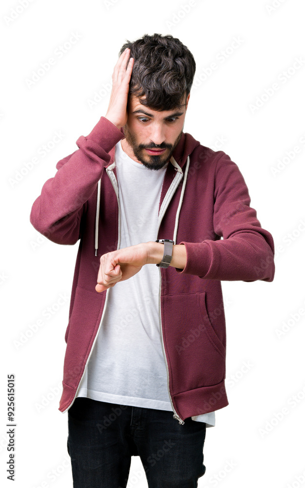 Young handsome man over isolated background Looking at the watch time worried, afraid of getting late Young handsome man over isolated background Looking at the watch time worried, afraid of getting late