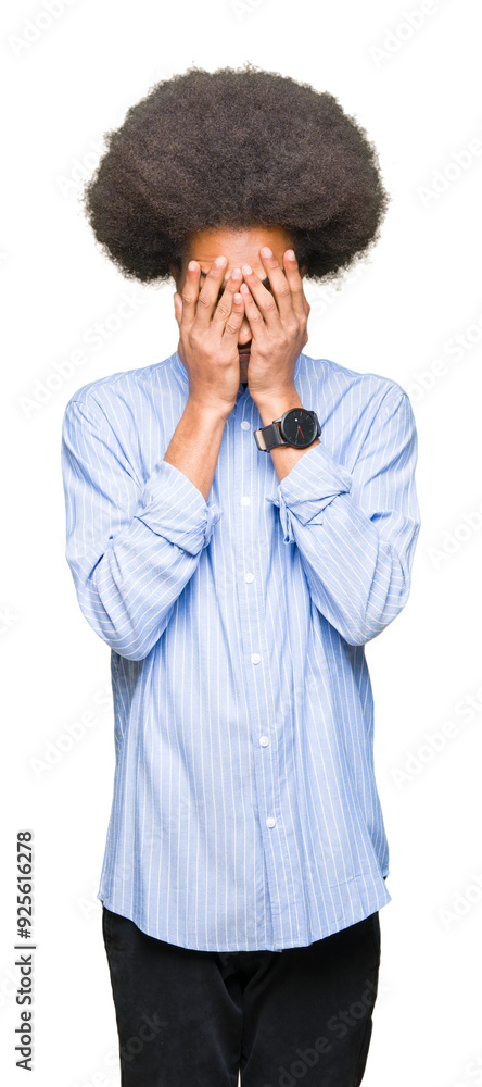 Young african american man with afro hair with sad expression covering face with hands while crying. Depression concept. Young african american man with afro hair with sad expression covering face with hands while crying. Depression concept.