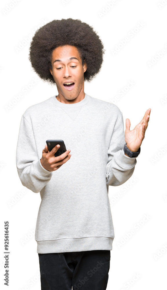 Young african american man with afro hair using a smartphone very happy and excited, winner expression celebrating victory screaming with big smile and raised hands Young african american man with afro hair using a smartphone very happy and excited, winner expression celebrating victory screaming with big smile and raised hands