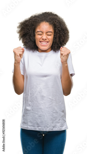 Young afro american woman over isolated background excited for success with arms raised celebrating victory smiling. Winner concept.