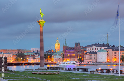 Photography Illuminated statue and waterfront view of historic buildings in Stockholm, Swede