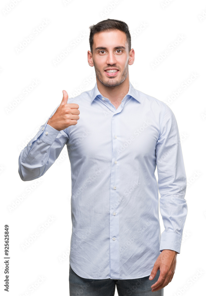 Handsome young businessman doing happy thumbs up gesture with hand. Approving expression looking at the camera with showing success. Handsome young businessman doing happy thumbs up gesture with hand. Approving expression looking at the camera with showing success.