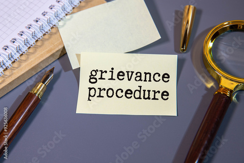 Obraz na płótnie Text grievance procedure on notepad with office tools, pen on financial report