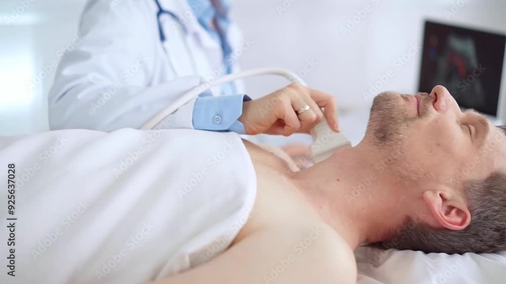 Doctor woman performing neck ultrasound exam on male patient. Medicine and health care Doctor woman performing neck ultrasound exam on male patient. Medicine and health care