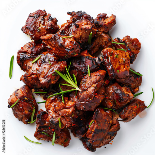 a plate of meat with a sprig of rosemary